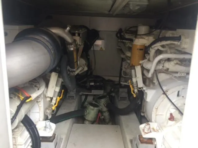  Yacht Photos Pics Engine room of a 2005 Azimut 43 yacht, showcasing dual engines and mechanical components.