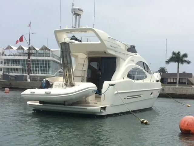  Yacht Photos Pics 2005 Azimut 43 yacht docked in marina, featuring sleek design and inflatable boat.