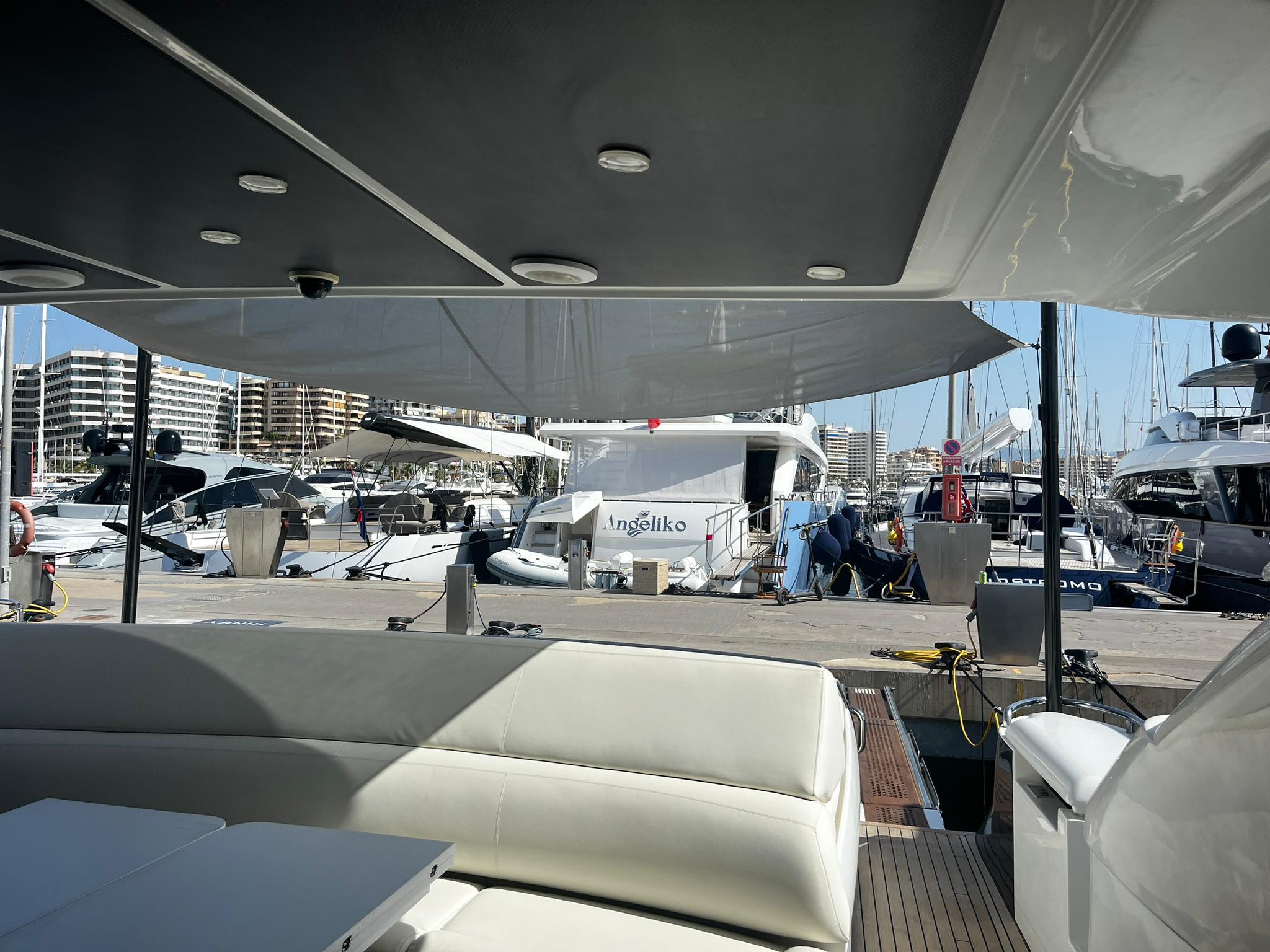 Luxury yacht docked at marina, view from Pershing 76, 2004 model.