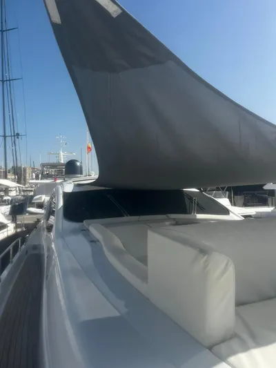  Yacht Photos Pics 2004 Pershing 76 yacht with sleek design and sunshade, docked at marina.