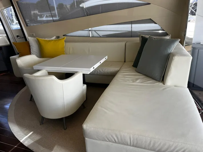  Yacht Photos Pics Luxurious interior of 2004 Pershing 76 yacht with white seating and modern decor.