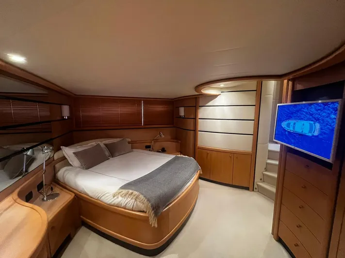  Yacht Photos Pics Luxurious bedroom interior of a 2004 Pershing 76 yacht with modern furnishings.