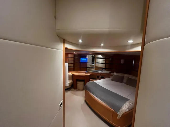  Yacht Photos Pics Luxurious bedroom interior of a 2004 Pershing 76 yacht with modern furnishings.