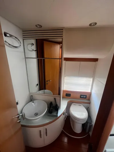  Yacht Photos Pics Luxurious bathroom in a 2004 Pershing 76 yacht, featuring modern fixtures and elegant design.