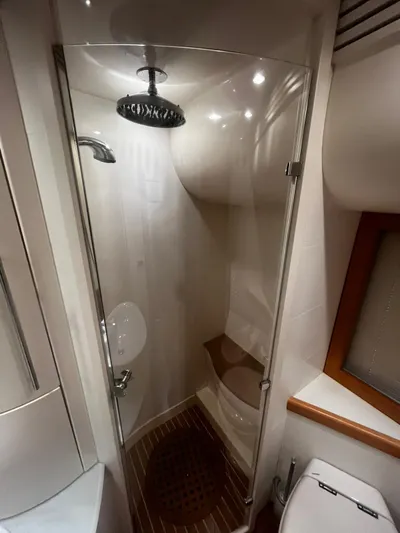  Yacht Photos Pics Shower area in 2004 Pershing 76 yacht with glass door and wooden floor.