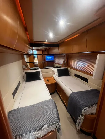  Yacht Photos Pics Luxurious twin cabin interior of 2004 Pershing 76 yacht with modern decor and ambient lighting.