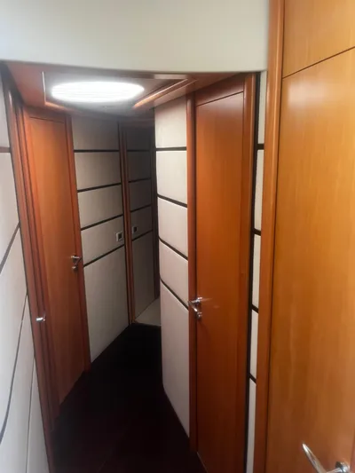  Yacht Photos Pics Interior hallway of a 2004 Pershing 76 yacht with wooden doors and modern design.