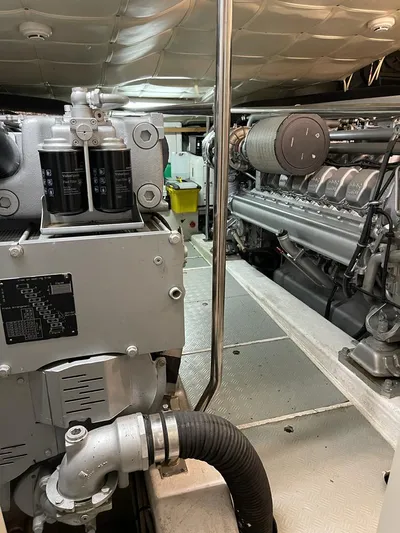  Yacht Photos Pics Engine room of a 2004 Pershing 76 yacht, showcasing mechanical components and systems.