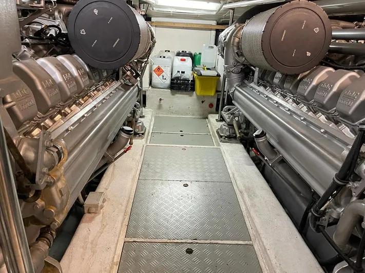  Yacht Photos Pics Engine room of a 2004 Pershing 76 yacht, featuring dual engines and maintenance equipment.