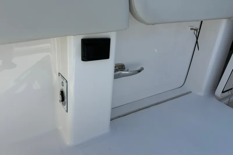  Yacht Photos Pics Invincible 40 Catamaran 2022 interior detail with sleek white finish and metal handle.