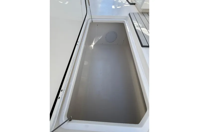  Yacht Photos Pics Storage compartment on 2022 Invincible 40 Catamaran, showcasing spacious interior design.
