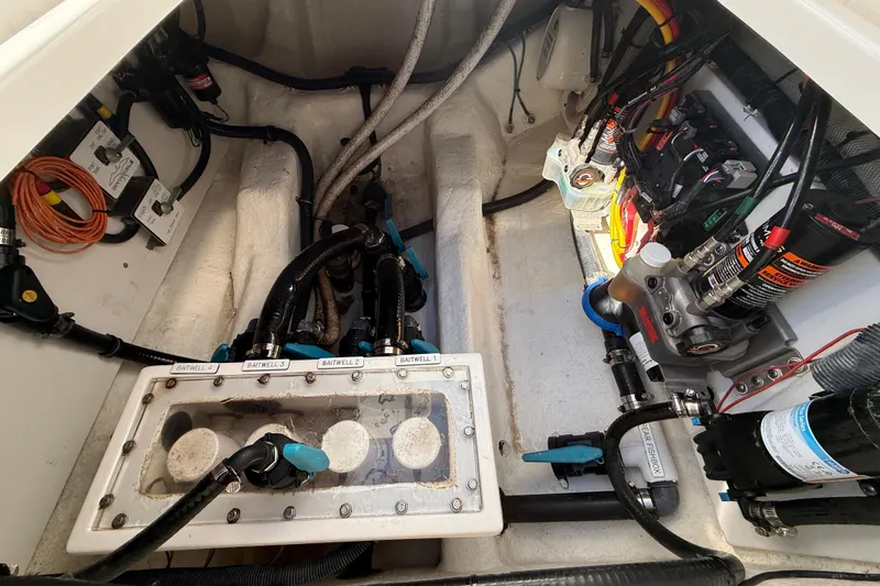  Yacht Photos Pics Engine compartment of a 2022 Invincible 40 Catamaran, showcasing baitwell system and wiring.