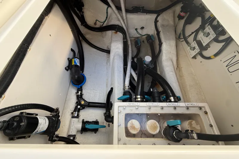  Yacht Photos Pics Engine compartment of 2022 Invincible 40 Catamaran with baitwell system and plumbing components.