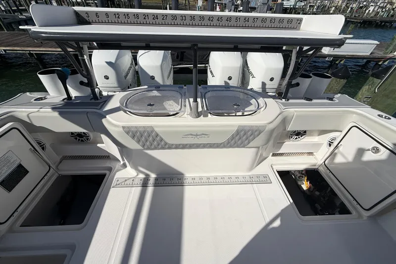  Yacht Photos Pics 2022 Invincible 40 Catamaran deck with storage compartments and fishing equipment.