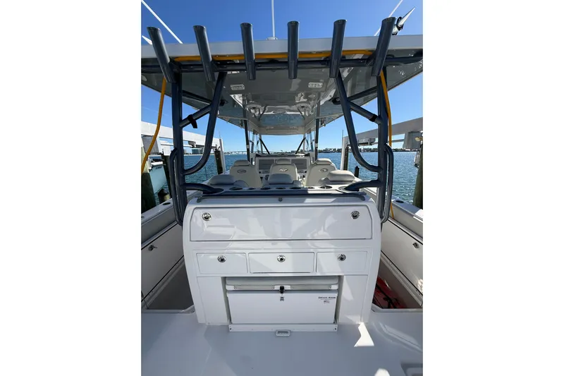  Yacht Photos Pics 2022 Invincible 40 Catamaran interior with seating and storage, docked by the water.