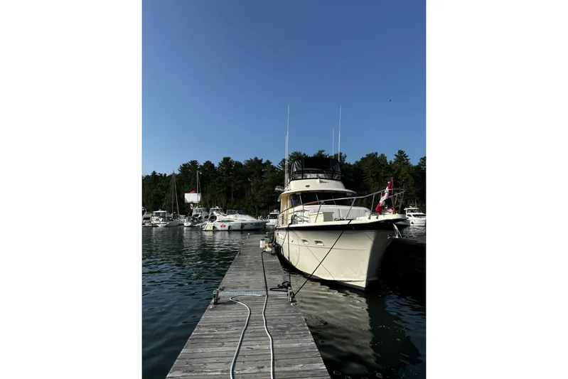  Yacht Photos Pics 1985 Hatteras 53 Extended Deckhouse Motor Yacht docked at marina, clear sky background.