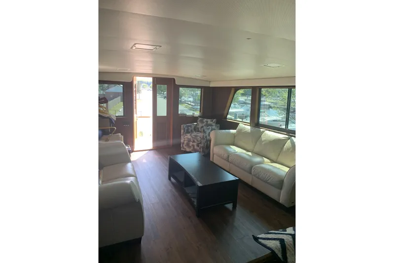  Yacht Photos Pics Interior of 1985 Hatteras 53 Motor Yacht with sofas and large windows.