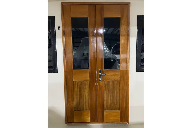  Yacht Photos Pics Wooden door on 1985 Hatteras 53 Extended Deckhouse Motor Yacht, featuring glass panels and metal handle.
