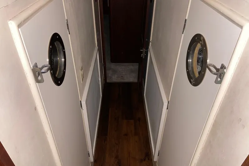  Yacht Photos Pics Narrow hallway inside 1985 Hatteras 53 Extended Deckhouse Motor Yacht with porthole doors.