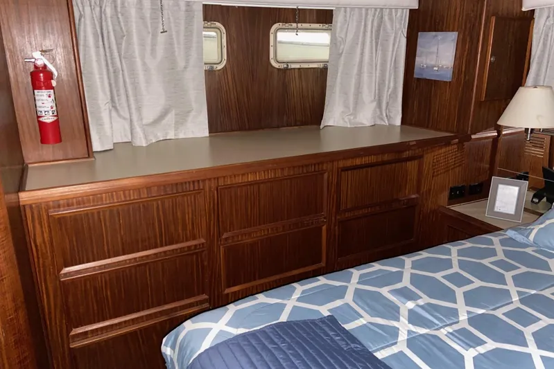  Yacht Photos Pics Interior of 1985 Hatteras 53 Motor Yacht with wood cabinetry and bed.