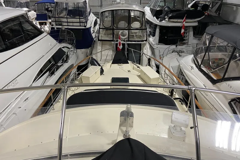  Yacht Photos Pics 1985 Hatteras 53 Extended Deckhouse Motor Yacht docked among other boats in a marina.