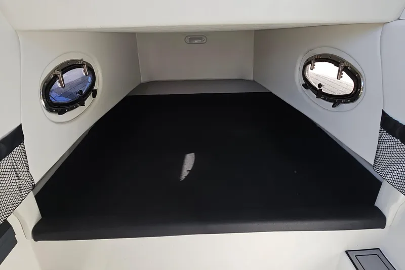  Yacht Photos Pics 2025 Nor-Tech 390 Sport Center Console cabin interior with portholes and black seating.