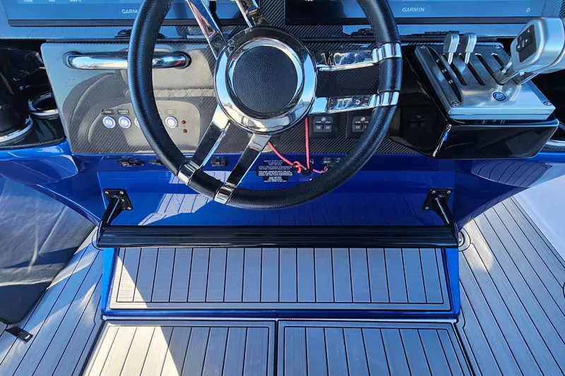  Yacht Photos Pics 2025 Nor-Tech 390 Sport Center Console helm with steering wheel and controls.