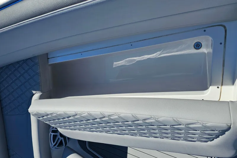  Yacht Photos Pics 2025 Nor-Tech 390 Sport Center Console interior detail with quilted upholstery and storage compartment.