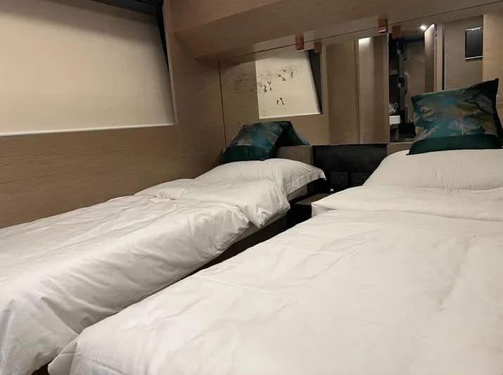  Yacht Photos Pics Luxurious twin bedroom in 2018 Ferretti Yachts 780, featuring elegant decor and plush bedding.