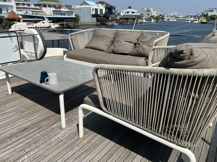  Yacht Photos Pics Outdoor seating on 2018 Ferretti Yachts 780, overlooking waterfront homes and boats.