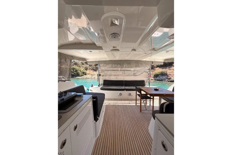  Yacht Photos Pics Interior view of 2020 Lagoon 46 yacht with elegant seating and scenic water backdrop.