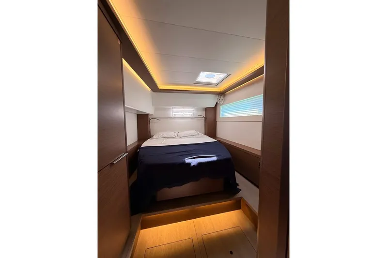  Yacht Photos Pics Luxurious cabin interior of 2020 Lagoon 46 yacht with modern lighting and cozy bed.