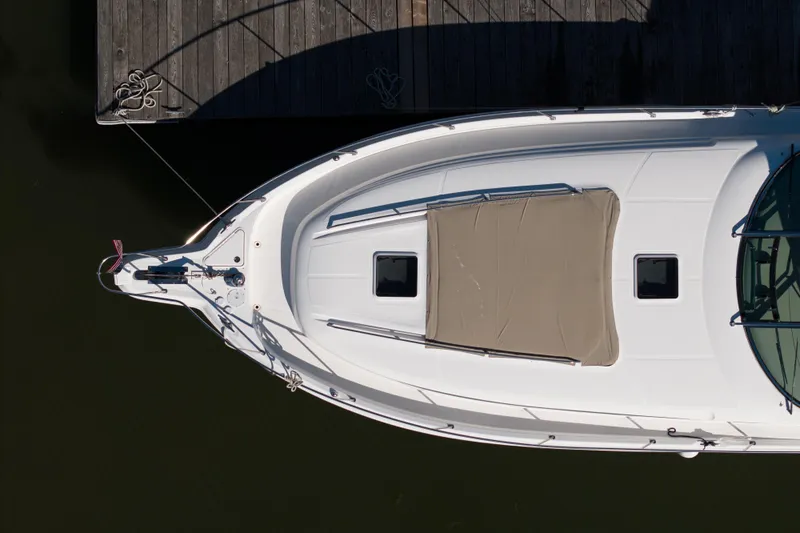  Yacht Photos Pics Top view of a 2004 Sea Ray Sundancer 460 yacht docked at a wooden pier.