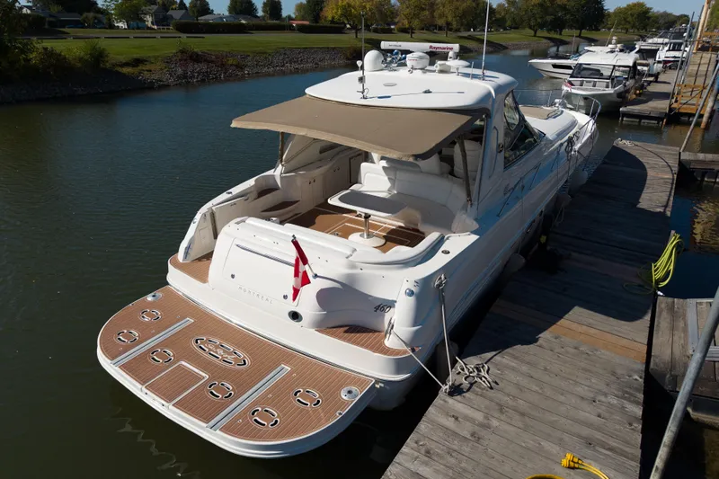  Yacht Photos Pics 2004 Sea Ray Sundancer 460 yacht docked at marina, featuring spacious deck and canopy.