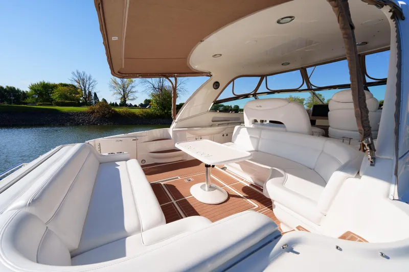  Yacht Photos Pics Luxurious 2004 Sea Ray Sundancer 460 yacht interior with white seating and wooden flooring.