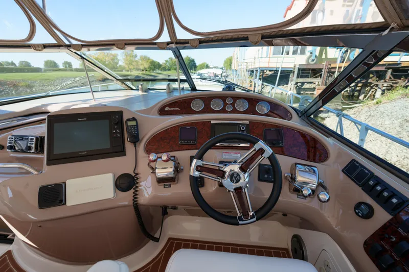  Yacht Photos Pics 2004 Sea Ray Sundancer 460 helm with navigation equipment and steering wheel.
