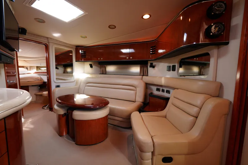  Yacht Photos Pics Luxurious interior of 2004 Sea Ray Sundancer 460 yacht with leather seating and wood finishes.