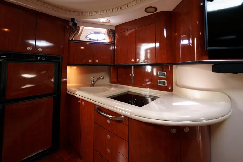  Yacht Photos Pics Luxurious 2004 Sea Ray Sundancer 460 yacht kitchen with sleek wood cabinetry and modern appliances.