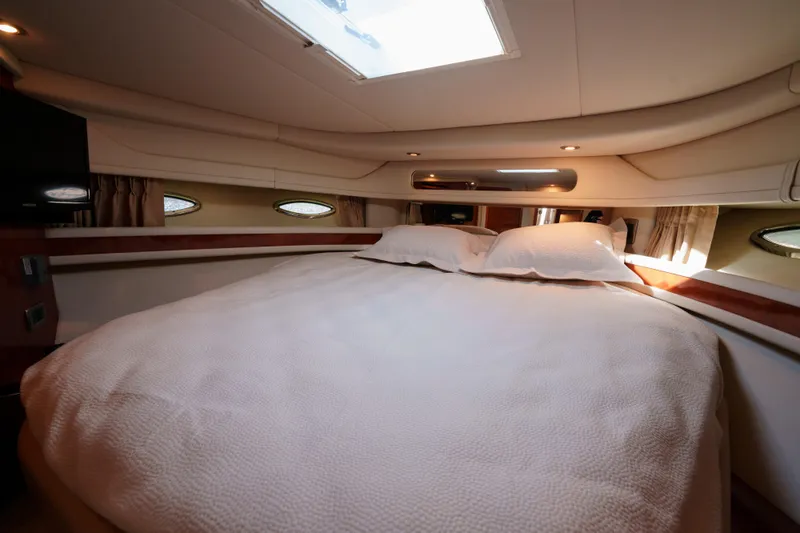  Yacht Photos Pics Luxurious cabin interior of 2004 Sea Ray Sundancer 460 yacht with cozy bedding.