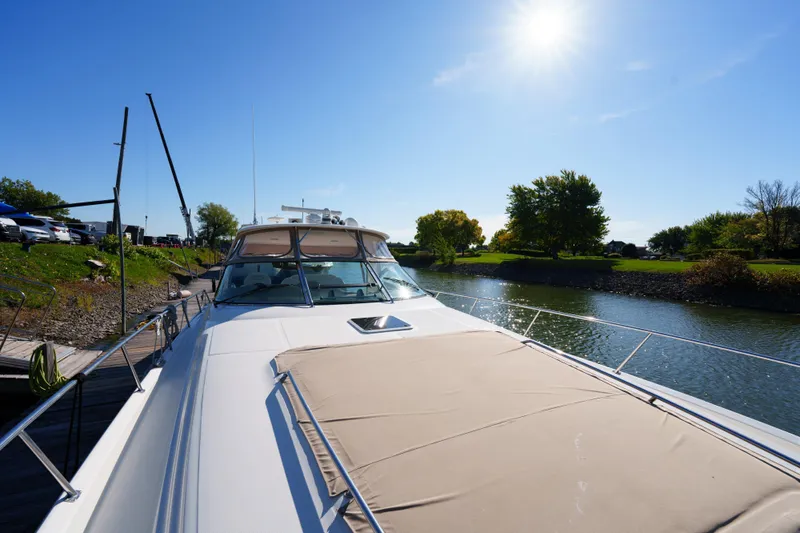  Yacht Photos Pics 2004 Sea Ray Sundancer 460 yacht docked on a sunny day by a scenic river.