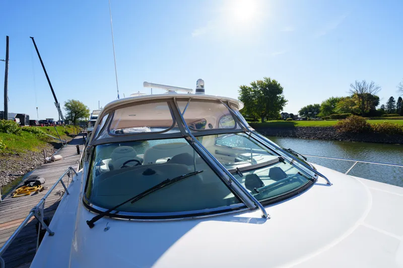  Yacht Photos Pics 2004 Sea Ray Sundancer 460 yacht docked by a scenic riverside.