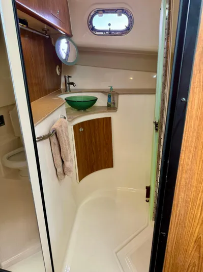  Yacht Photos Pics 2009 Pursuit OS 375 Offshore boat bathroom with wood accents and modern fixtures.
