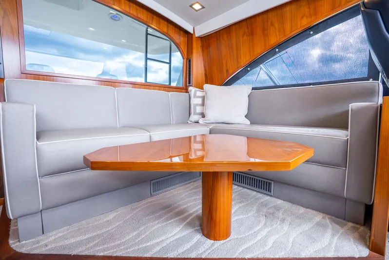 Unbridled Yacht Photos Pics Enclosed Bridge Settee and Cocktail Table