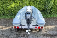 2021 AB Inflatables Lammina 10 AL boat on trailer, rear view, outdoors.