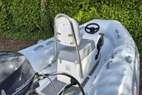 2021 AB Inflatables Lammina 10 AL boat interior with steering wheel and motor.