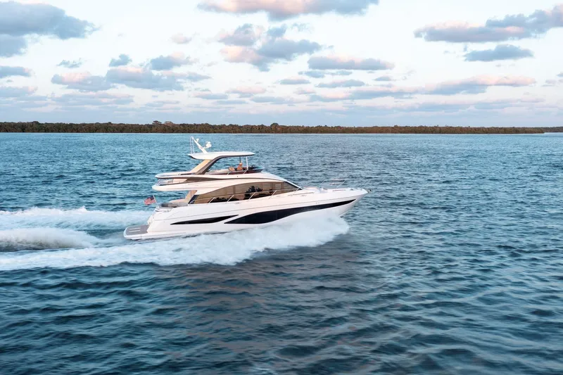  Yacht Photos Pics 2024 Princess F65 yacht cruising on open water under a partly cloudy sky.
