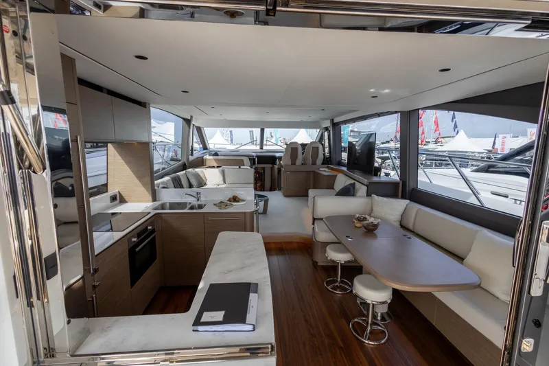  Yacht Photos Pics Luxurious interior of 2024 Princess F65 yacht with modern kitchen and seating area.