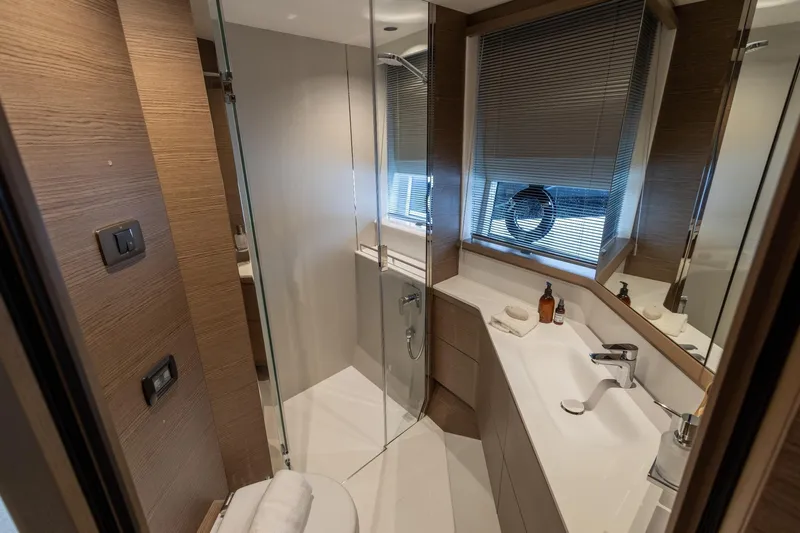  Yacht Photos Pics Luxurious bathroom in 2024 Princess F65 yacht with modern fixtures and elegant design.