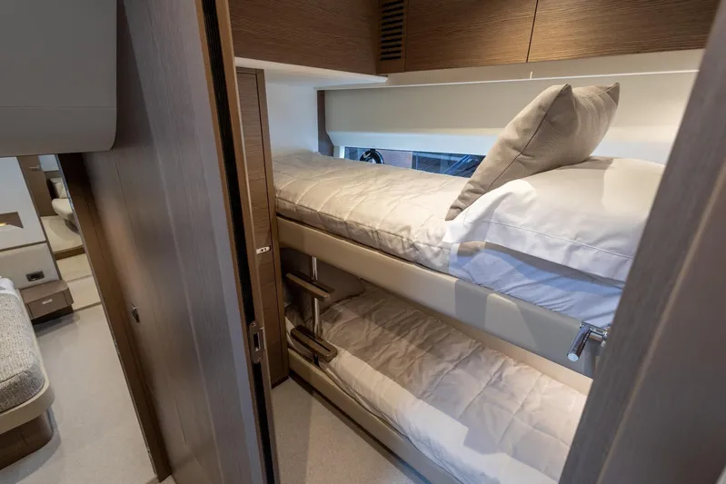  Yacht Photos Pics 2024 Princess F65 yacht interior with cozy bunk beds and modern wood finish.