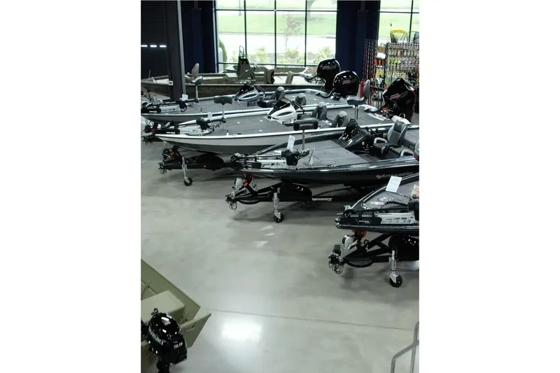  Yacht Photos Pics Indoor showroom displaying multiple boats, including the 2025 Pioneer Pelagic 270 model.